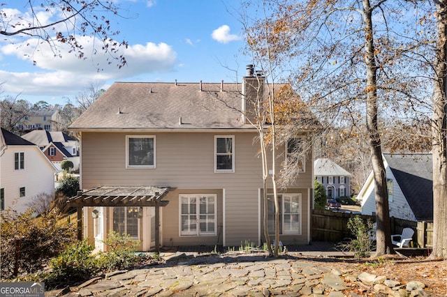 rear view of house with a pergola