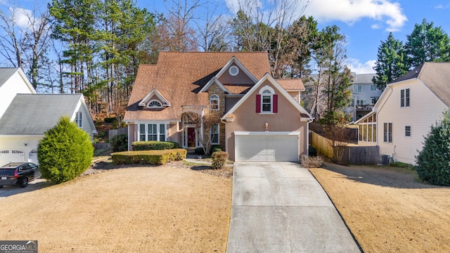 view of front of home featuring a garage and cooling unit