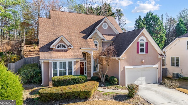 front of property featuring central AC unit and a garage