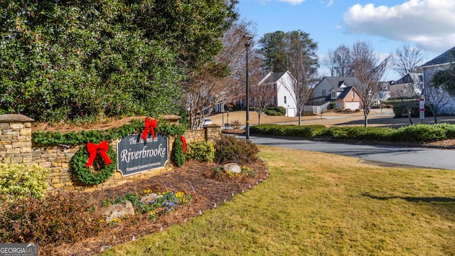 community sign featuring a lawn