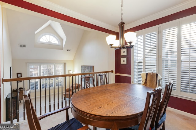 carpeted dining room featuring ornamental molding, lofted ceiling, and a notable chandelier