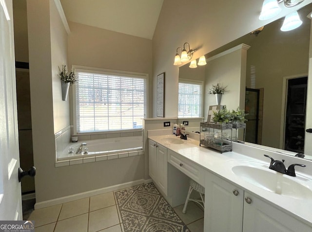 bathroom with an inviting chandelier, vanity, a bath, vaulted ceiling, and tile patterned floors