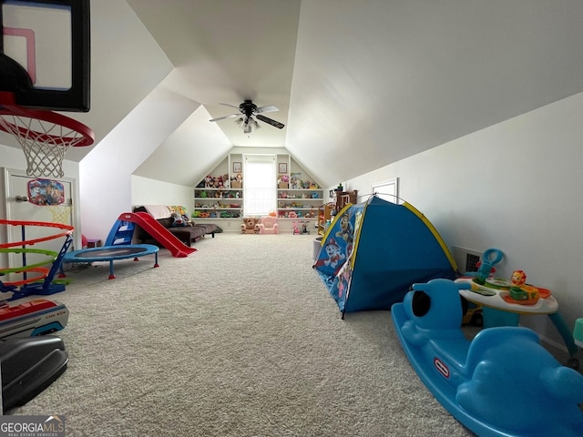 rec room with built in shelves, ceiling fan, lofted ceiling, and carpet