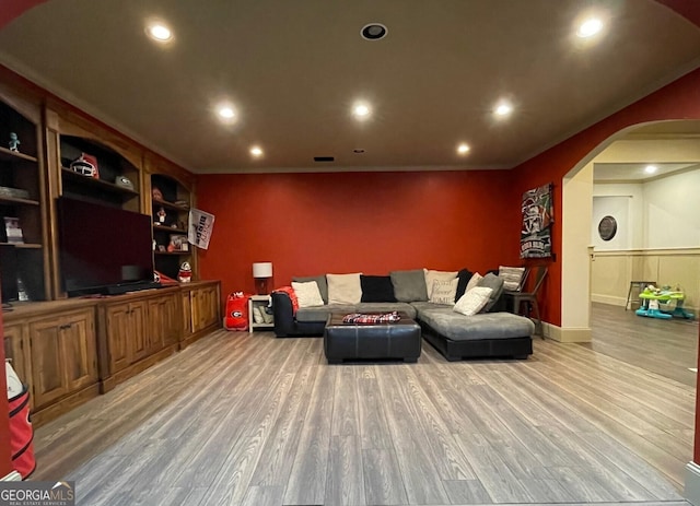 living room with wood-type flooring and built in features