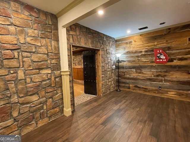 empty room with dark hardwood / wood-style flooring and crown molding