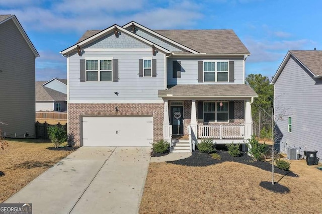 view of front of property with a front yard, a garage, and covered porch