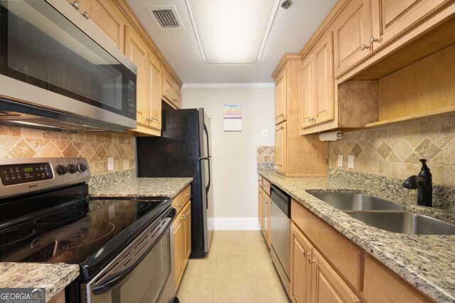 kitchen featuring sink, decorative backsplash, light stone countertops, light tile patterned floors, and stainless steel appliances