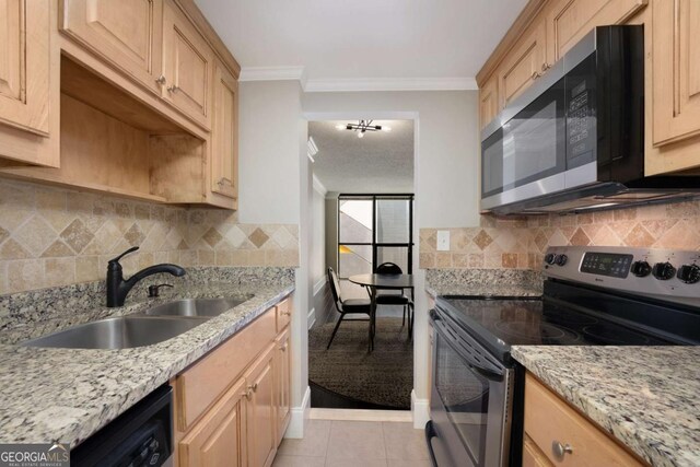 kitchen with sink, backsplash, light brown cabinetry, light tile patterned floors, and appliances with stainless steel finishes