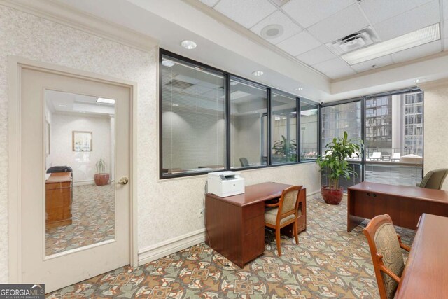 office with a drop ceiling and crown molding