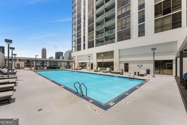 view of swimming pool featuring a patio area