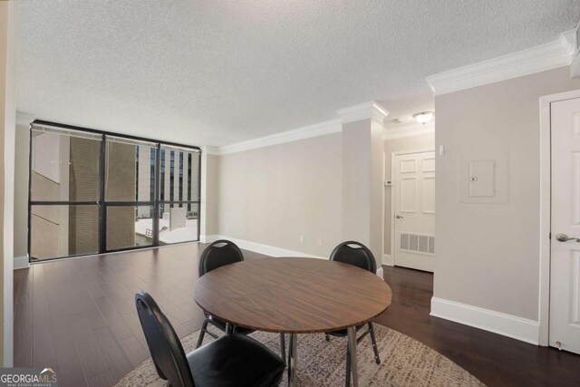 dining room featuring dark hardwood / wood-style flooring, a textured ceiling, and crown molding