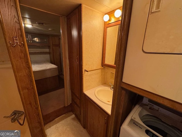 bathroom with vanity and washer / clothes dryer