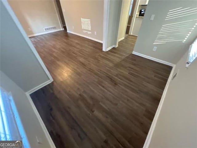 spare room featuring dark hardwood / wood-style flooring