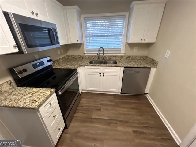 kitchen featuring white cabinetry, sink, stainless steel appliances, and dark hardwood / wood-style floors