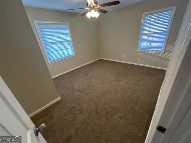 carpeted empty room featuring ceiling fan