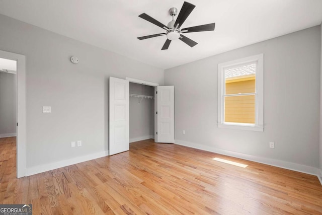 unfurnished bedroom with ceiling fan, a closet, and light hardwood / wood-style flooring