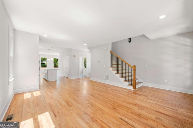 unfurnished living room featuring light hardwood / wood-style flooring