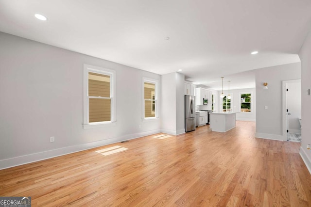 unfurnished living room with light hardwood / wood-style flooring