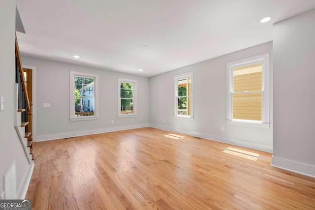 empty room featuring light hardwood / wood-style flooring and a healthy amount of sunlight