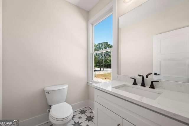 bathroom featuring vanity, toilet, and a wealth of natural light