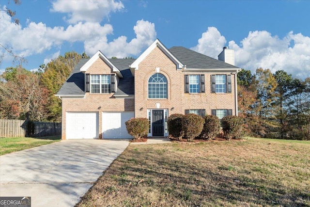 view of front of house with a garage and a front lawn