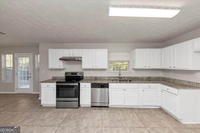 kitchen with a healthy amount of sunlight, sink, white cabinets, and stainless steel appliances