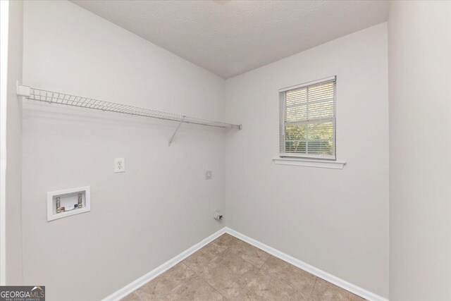 laundry room with washer hookup, hookup for an electric dryer, and a textured ceiling