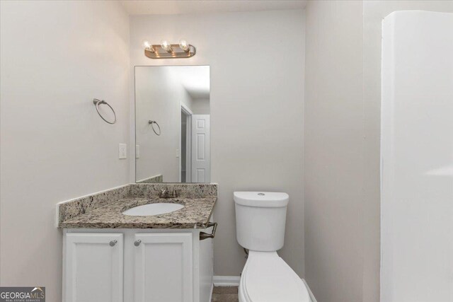 bathroom featuring vanity and toilet