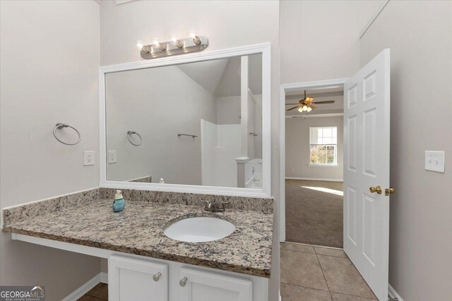 bathroom with tile patterned flooring, vanity, and ceiling fan