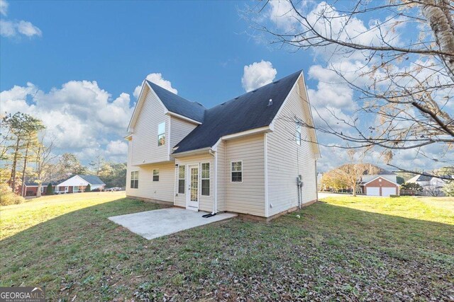 rear view of house with a yard and a patio
