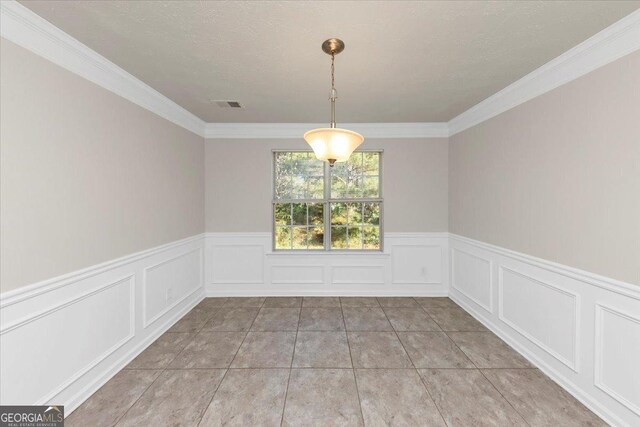 unfurnished dining area featuring crown molding, light tile patterned floors, and a textured ceiling
