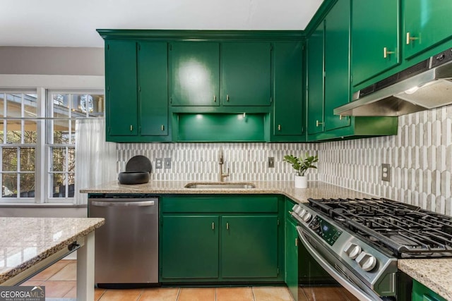 kitchen featuring light stone counters, appliances with stainless steel finishes, sink, and backsplash