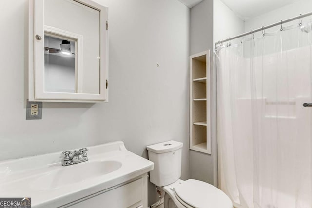 bathroom with vanity, toilet, and a shower with shower curtain