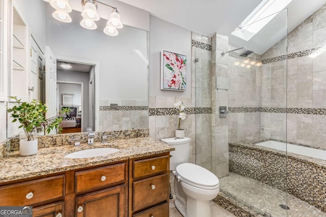 full bathroom with lofted ceiling with skylight, plus walk in shower, tile walls, vanity, and tile patterned floors