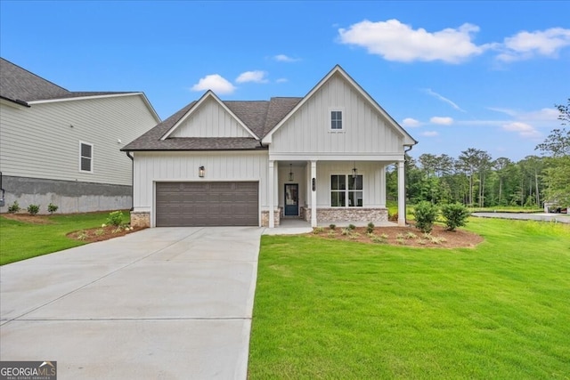 modern farmhouse featuring a front yard, covered porch, and a garage