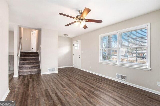 unfurnished living room featuring dark hardwood / wood-style floors and ceiling fan