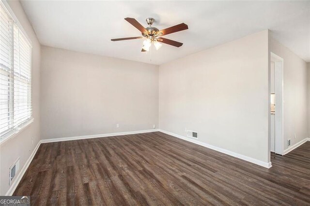 spare room featuring dark hardwood / wood-style floors and ceiling fan