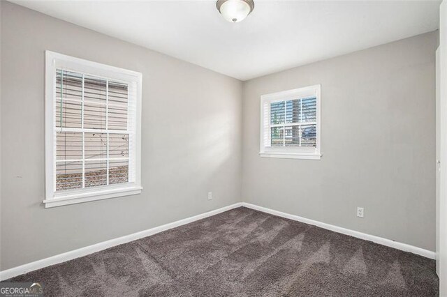 unfurnished room featuring carpet