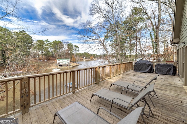 deck with a water view and a grill