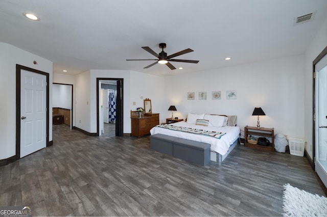 bedroom with a walk in closet, ceiling fan, and dark hardwood / wood-style floors