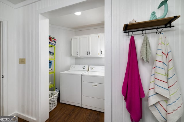 laundry room with washer and clothes dryer and dark wood-type flooring