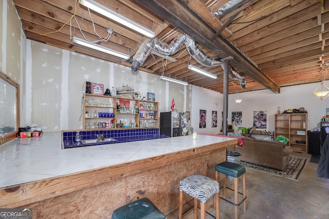 bar with tile counters and concrete floors