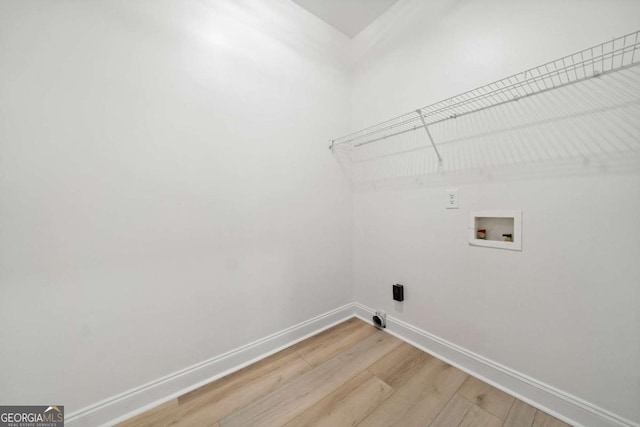 laundry area featuring washer hookup and light hardwood / wood-style floors