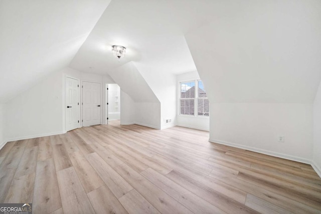 bonus room featuring light hardwood / wood-style floors and lofted ceiling