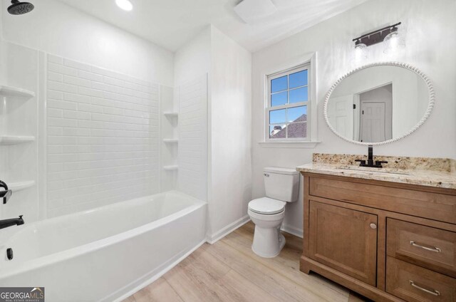 full bathroom with shower / tub combination, vanity, hardwood / wood-style flooring, and toilet