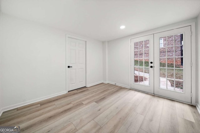 empty room featuring light hardwood / wood-style floors and french doors