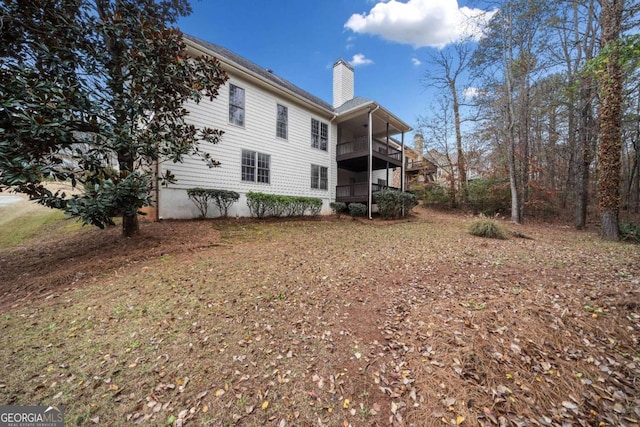 back of property featuring a balcony