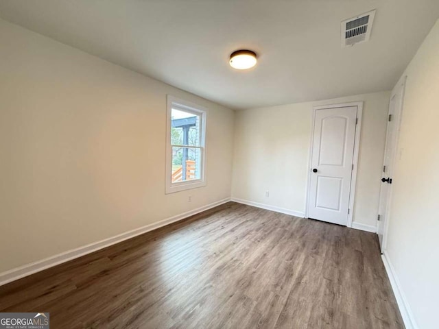 spare room with hardwood / wood-style floors