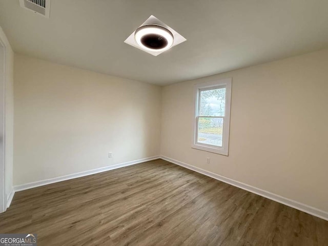 empty room featuring dark wood-type flooring