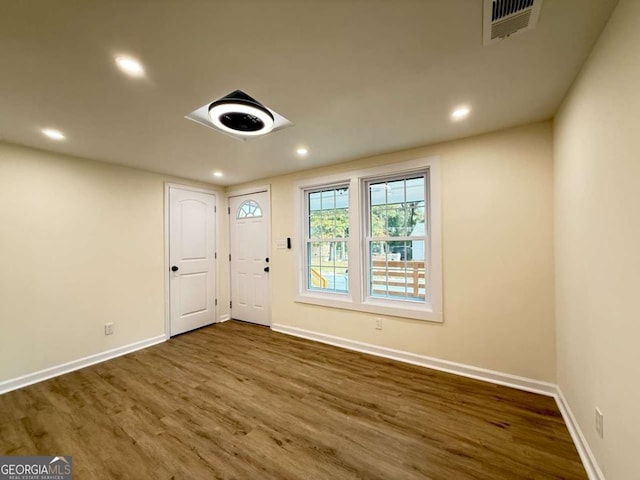 unfurnished room with dark wood-type flooring